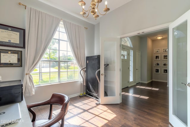 interior space with hardwood / wood-style floors, a notable chandelier, and french doors