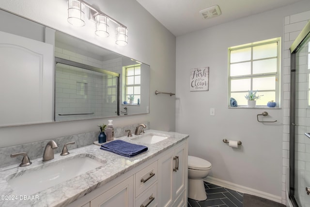 bathroom with a stall shower, toilet, tile patterned floors, and double vanity