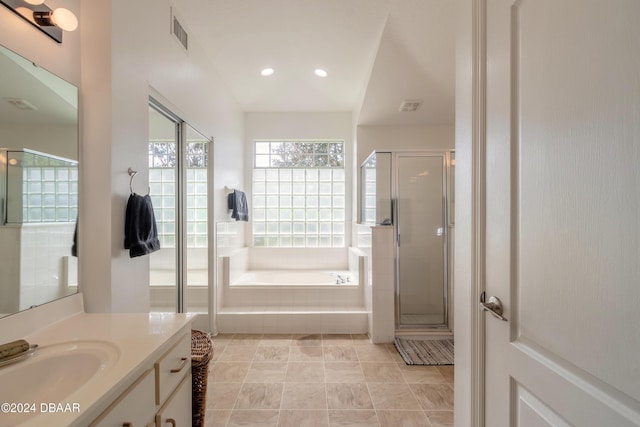 full bath with a bath, a shower stall, vanity, and recessed lighting