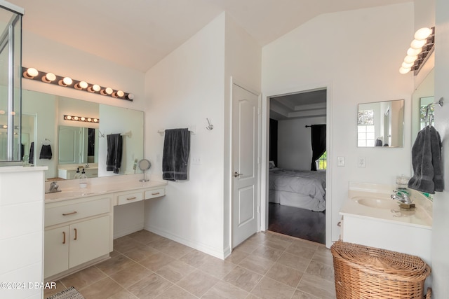 bathroom featuring vanity and vaulted ceiling