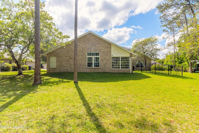 rear view of house with a lawn