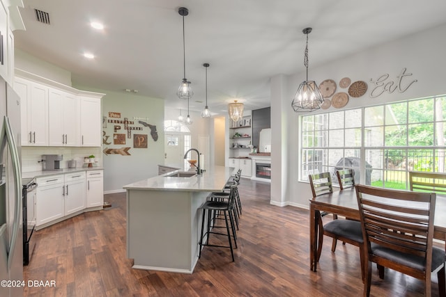 kitchen with white cabinets, dark hardwood / wood-style floors, and plenty of natural light