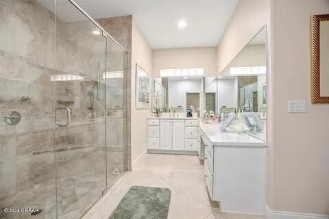 bathroom featuring vanity and a shower with shower door