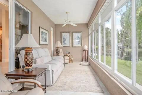 sunroom featuring ceiling fan and a healthy amount of sunlight