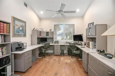 office area with light hardwood / wood-style flooring, built in desk, and ceiling fan