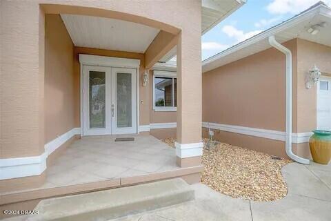 doorway to property with french doors