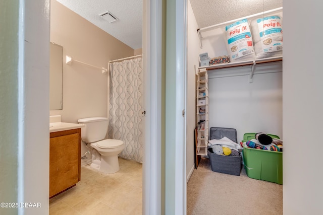 1600 Big Tree Rd Unit E8, Daytona Beach, FL 32119 - bathroom featuring vanity, a textured ceiling, toilet, and a shower with curtain