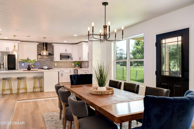 550 Eagle Dr, Holly Hill, FL 32117 - dining room featuring light wood-type flooring, recessed lighting, and a chandelier