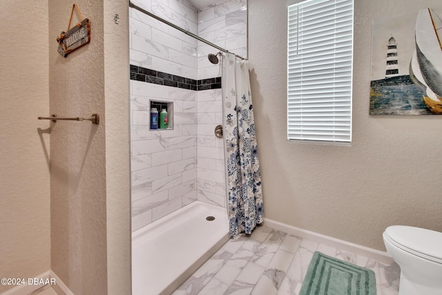 bathroom with toilet and a shower with shower curtain