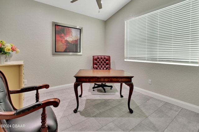 home office featuring vaulted ceiling, light tile patterned floors, and ceiling fan