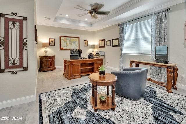 office area featuring crown molding, ceiling fan, and a raised ceiling