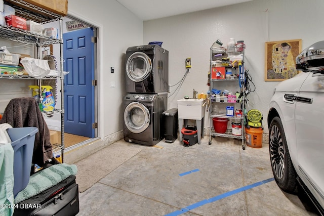 laundry area featuring stacked washer / dryer and sink