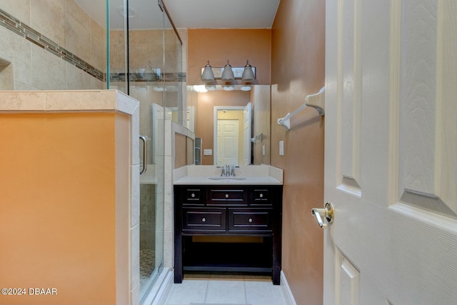 bathroom featuring tile patterned floors, vanity, and walk in shower