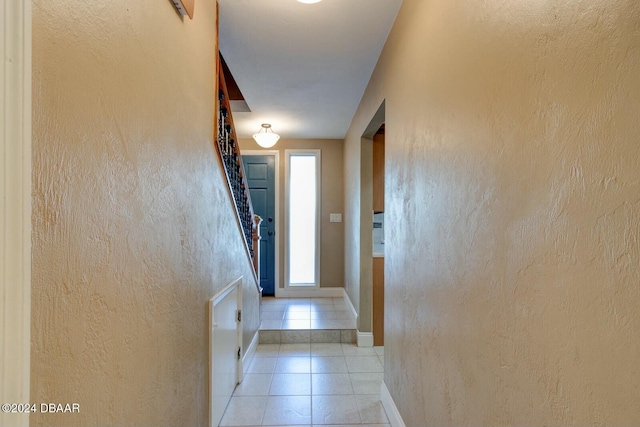 hall featuring light tile patterned flooring