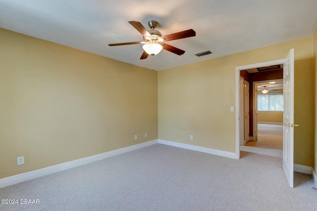 empty room featuring light carpet and ceiling fan