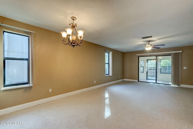 unfurnished room with ceiling fan with notable chandelier