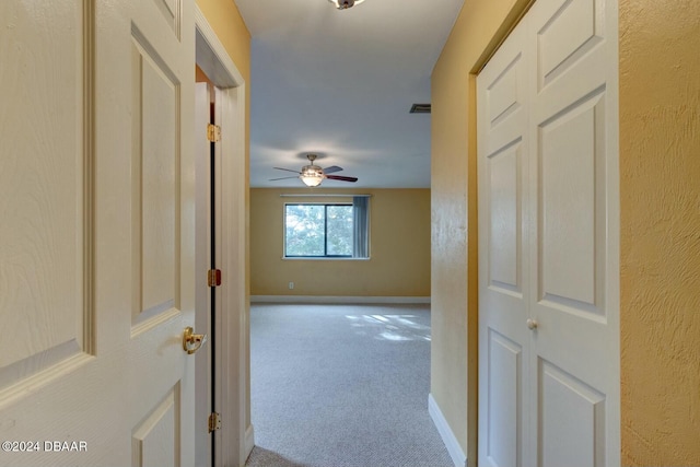 hallway with light carpet