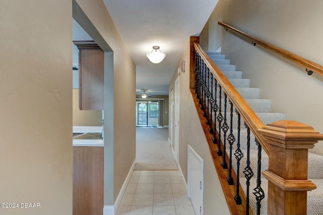 stairs with tile patterned flooring and ceiling fan