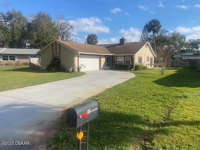 single story home with fence, an attached garage, a chimney, concrete driveway, and a front lawn