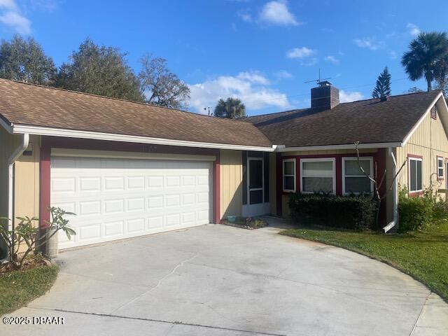 single story home with a garage, concrete driveway, a chimney, and a shingled roof