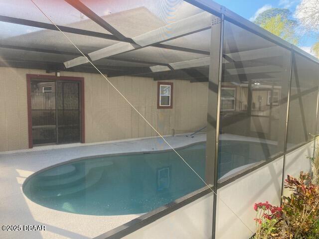 view of swimming pool with a lanai