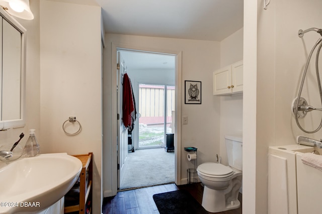 bathroom with hardwood / wood-style floors, lofted ceiling, sink, and toilet