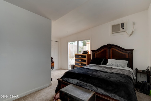 carpeted bedroom featuring an AC wall unit and lofted ceiling