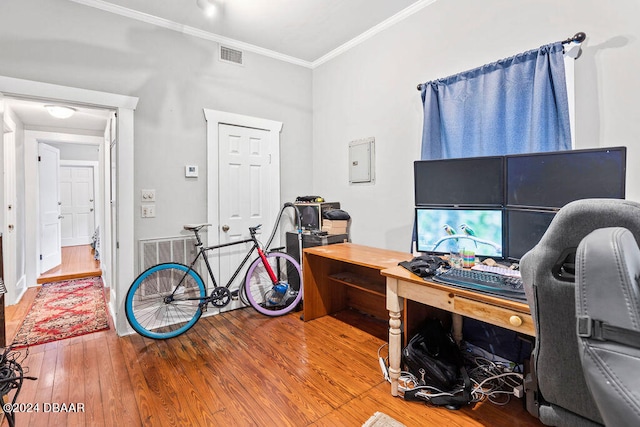 office space with wood-type flooring and ornamental molding