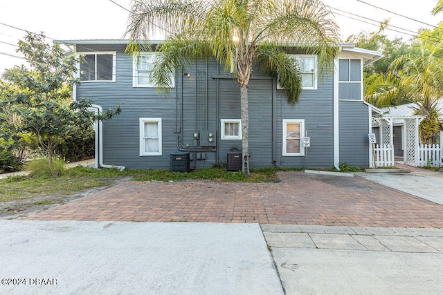 back of house with central air condition unit