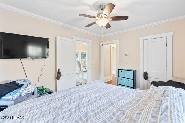 bedroom featuring ceiling fan and crown molding