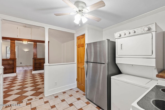 clothes washing area featuring ceiling fan, stacked washer and clothes dryer, ornate columns, and ornamental molding