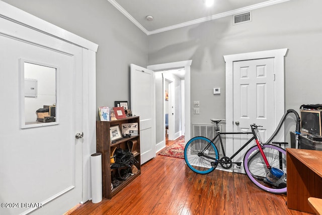 misc room with hardwood / wood-style flooring and crown molding