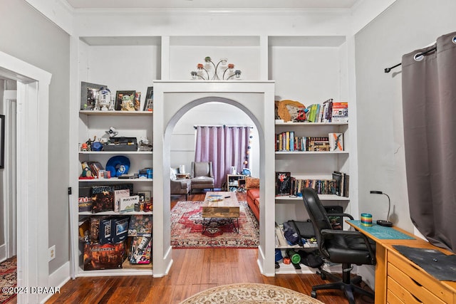 home office featuring wood-type flooring and crown molding