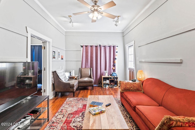 living room with hardwood / wood-style flooring, ceiling fan, track lighting, and ornamental molding