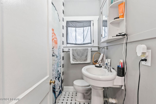 bathroom featuring walk in shower and toilet