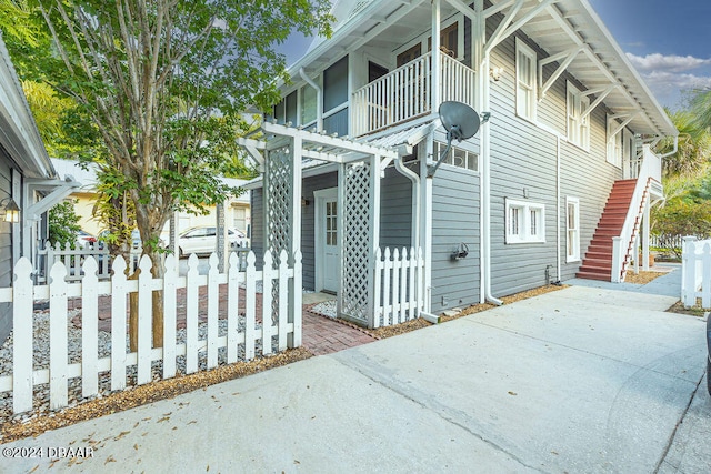 view of property exterior featuring a balcony and a patio area