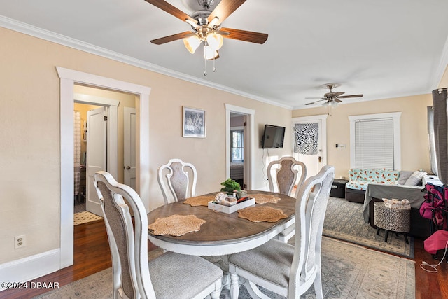 dining space featuring ornamental molding, dark hardwood / wood-style flooring, and ceiling fan