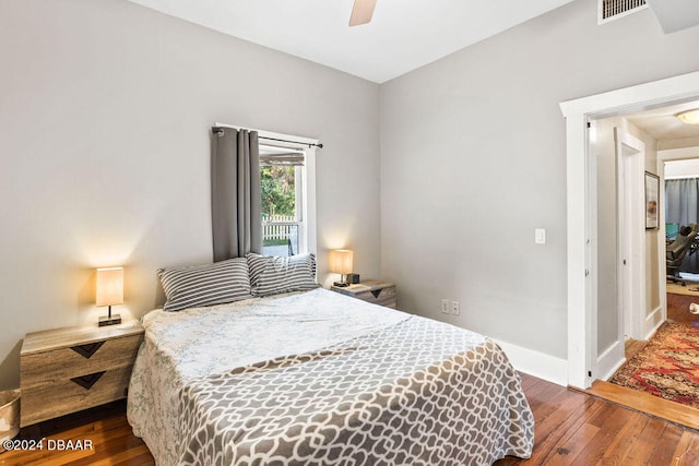 bedroom with dark hardwood / wood-style flooring and ceiling fan