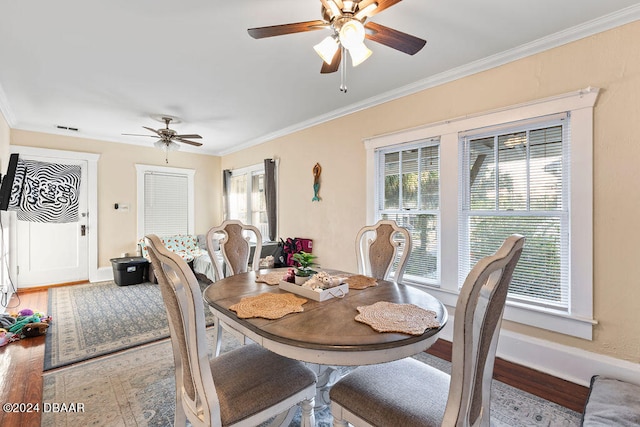 dining space with ornamental molding, hardwood / wood-style floors, a healthy amount of sunlight, and ceiling fan