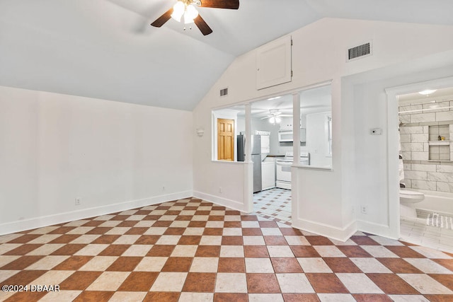 unfurnished living room with lofted ceiling and light tile patterned floors