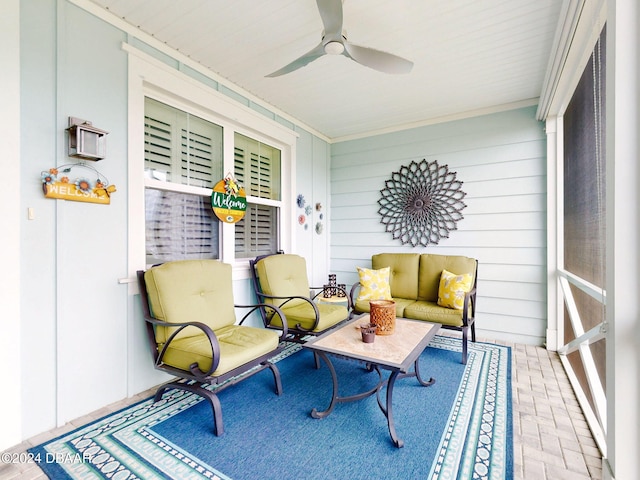 sunroom / solarium featuring ceiling fan