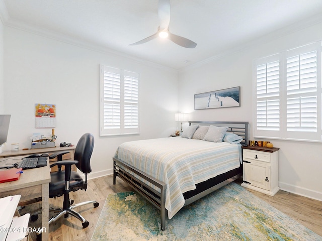 bedroom featuring crown molding, light hardwood / wood-style flooring, and ceiling fan