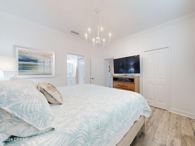 bedroom with a notable chandelier, ornamental molding, ensuite bathroom, and light wood-type flooring