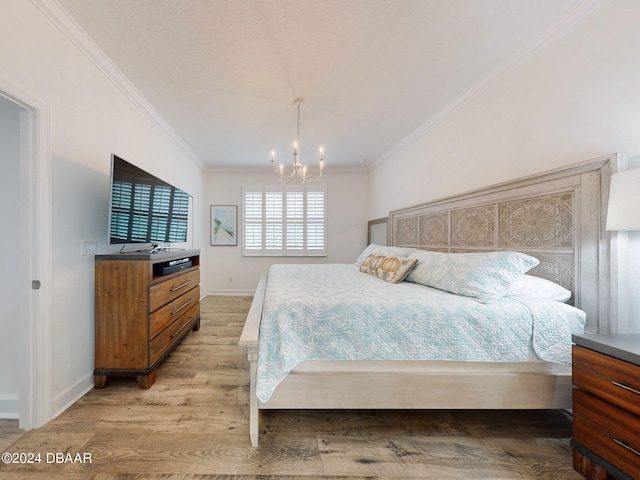 bedroom with crown molding, an inviting chandelier, and light hardwood / wood-style flooring