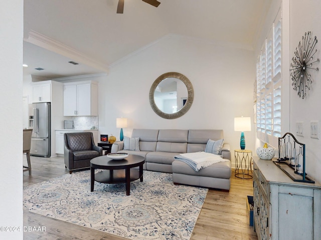 living room with crown molding, vaulted ceiling, light hardwood / wood-style floors, and ceiling fan