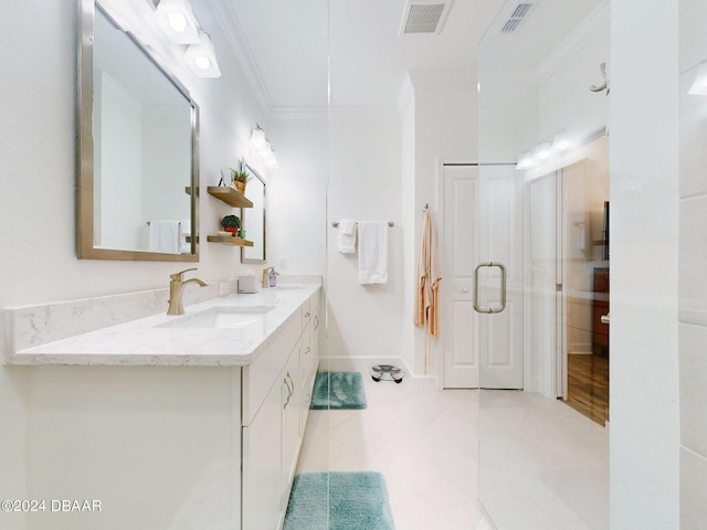 bathroom featuring vanity, crown molding, a shower with door, and tile patterned floors