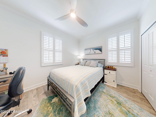 bedroom featuring crown molding, ceiling fan, a closet, and light hardwood / wood-style flooring