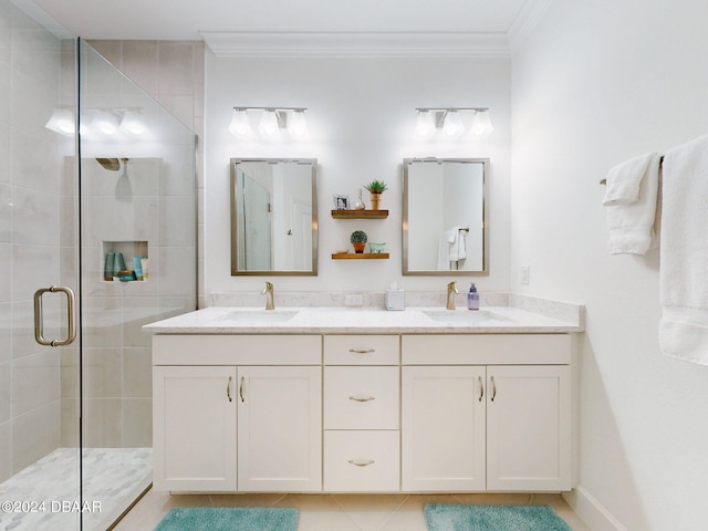 bathroom with an enclosed shower, vanity, crown molding, and tile patterned flooring