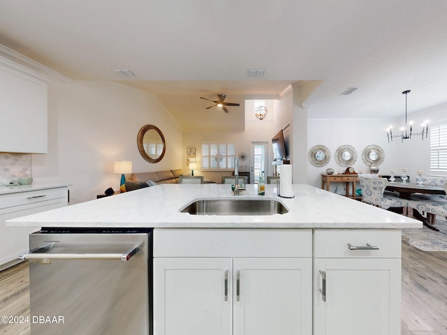 kitchen with sink, stainless steel dishwasher, white cabinets, and light stone counters