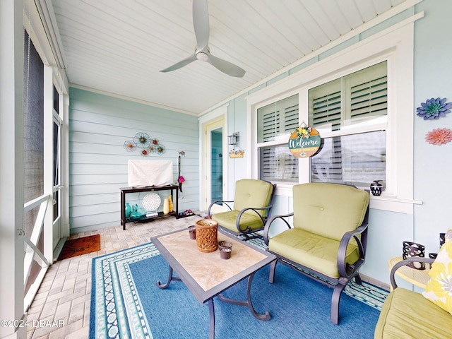 sunroom / solarium featuring ceiling fan